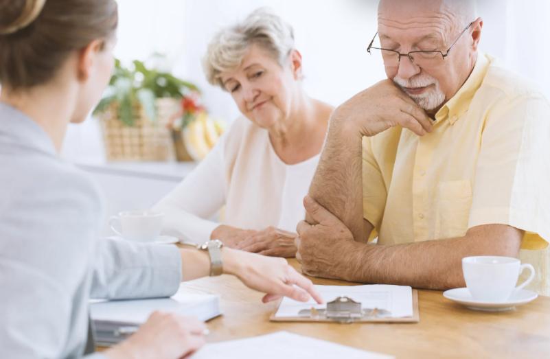 Senior couple reviewing final expense life insurance options with an advisor
