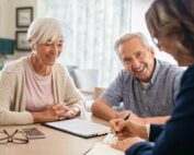 Smiling senior couple meeting with a professional insurance advisor at home
