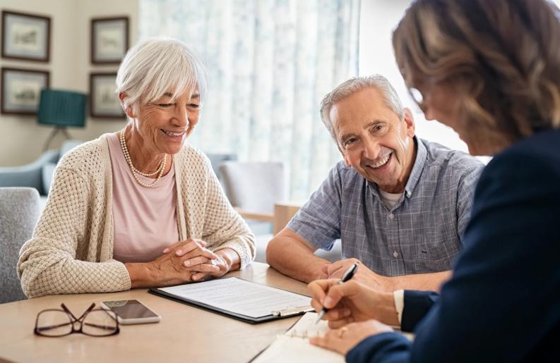 Smiling senior couple meeting with a professional insurance advisor at home