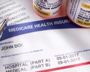 Close-up of Medicare health insurance form and prescription bottles
