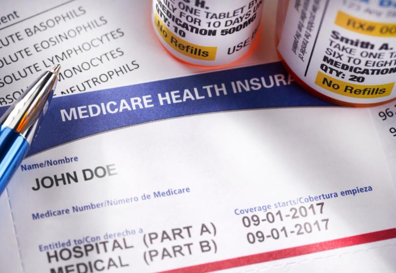 Close-up of Medicare health insurance form and prescription bottles
