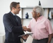 Insurance agent shaking hands with client after successful lead conversion