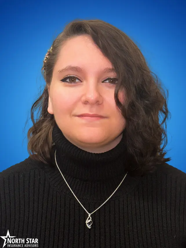 Ashley Stewart, licensed Medicare advisor, professional headshot with blue backdrop