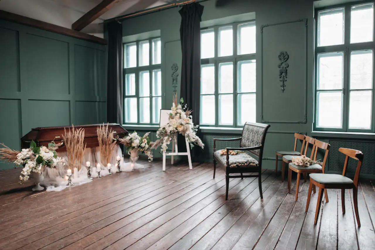 Funeral home interior setup with casket and floral arrangements