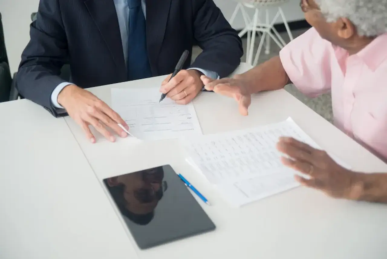 Final expense agent reviewing documents with a senior client