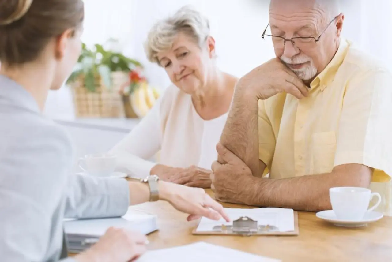 Senior couple reviewing final expense life insurance options with an advisor