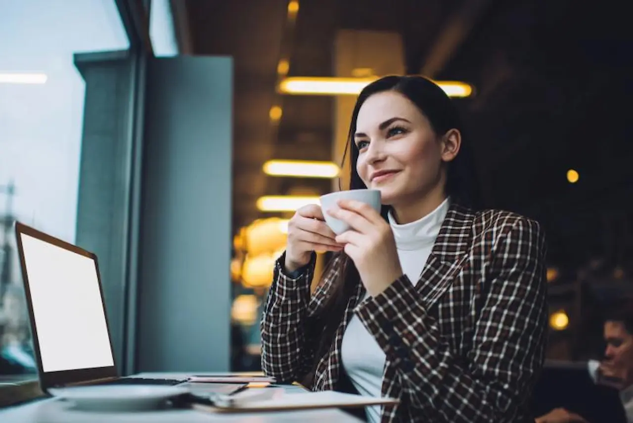 Life Insurance Agent Working Remotely Remote life insurance agent working in a café with a laptop and coffee